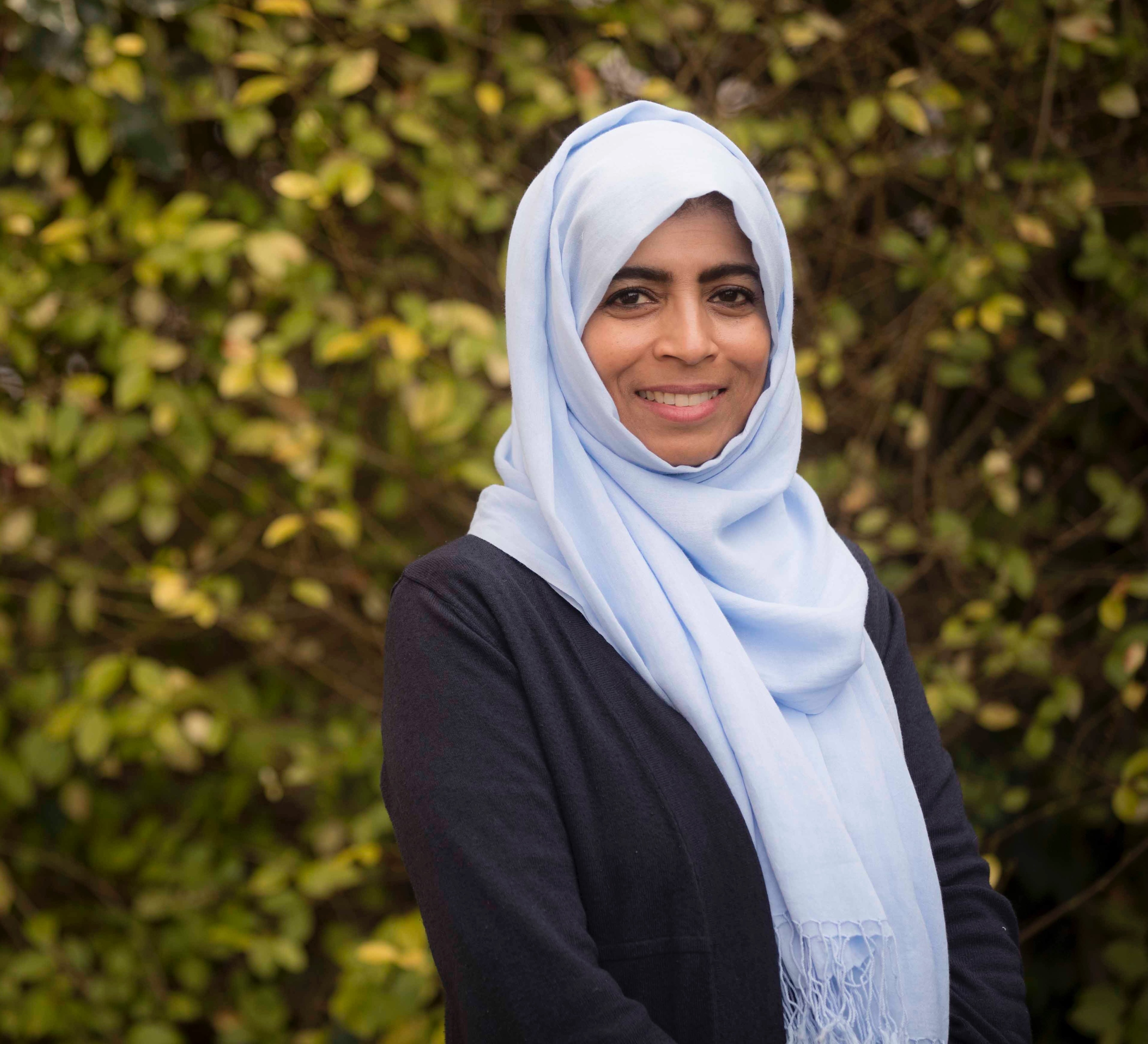 Warm portrait of Raha Hussain-Farnsworth, the webinar host